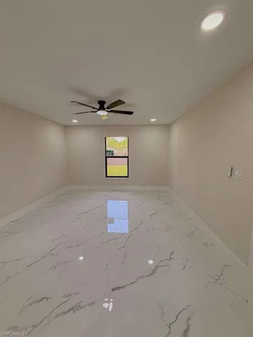Unfurnished room with recessed lighting, light marble finish floors, and a ceiling fan