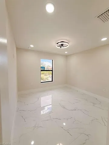 Spare room with recessed lighting and light marble finish flooring