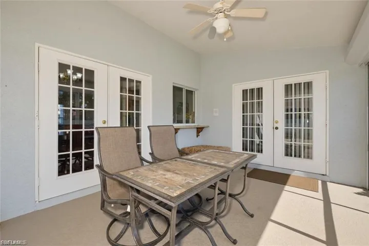 View of patio with french doors, a ceiling fan, and outdoor dining space