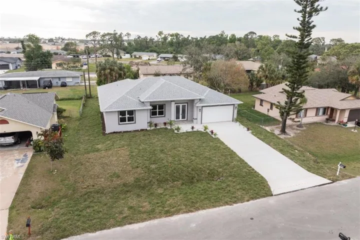 View of front of home featuring a garage and a front lawn