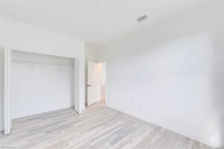Unfurnished bedroom featuring a closet and light wood-type flooring