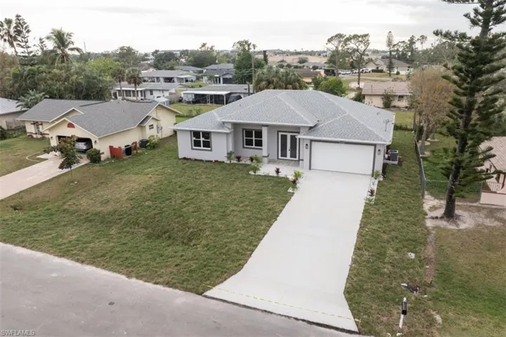View of front of house with a front yard and a garage