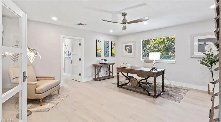 Office with light wood-type flooring, ceiling fan, and recessed lighting