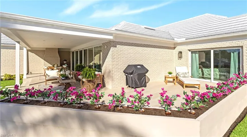 View of patio featuring a grill