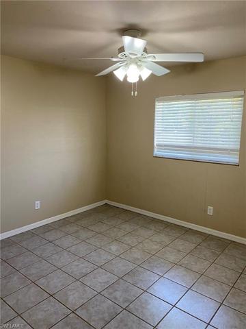 The front Guest Bedroom also features tiled flooring, large window, ceiling fan and ample closet.