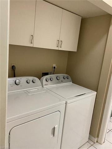 Interior Laundry room features Whirlpool Washer and Dryer and built in cabinets with a wall Pantry on opposite wall