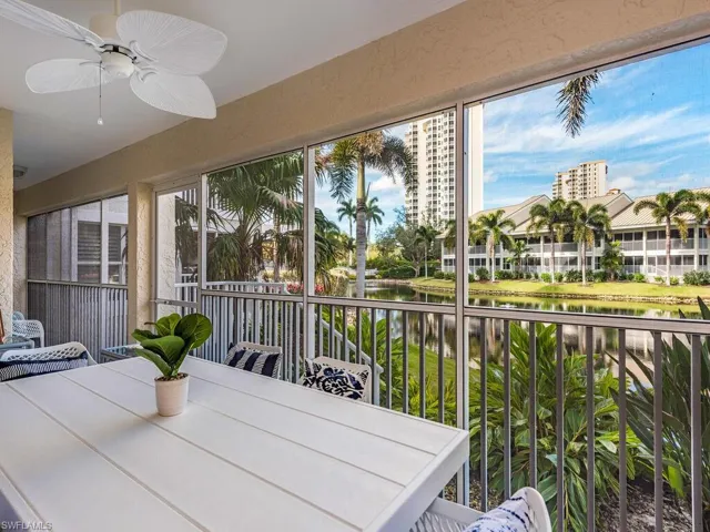 Sunroom with plenty of natural light, ceiling fan, and a water view