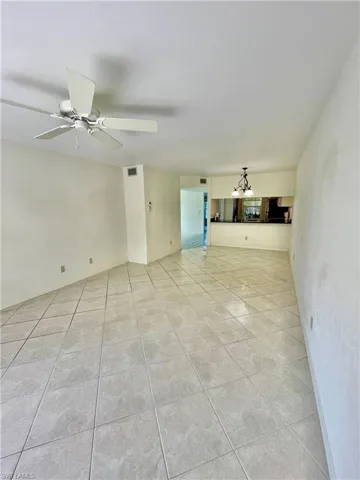 Tiled spare room with ceiling fan