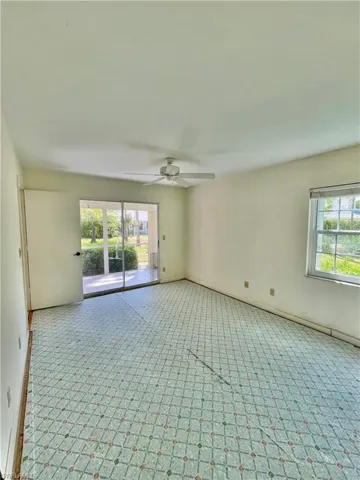 Empty room with ceiling fan and a healthy amount of sunlight