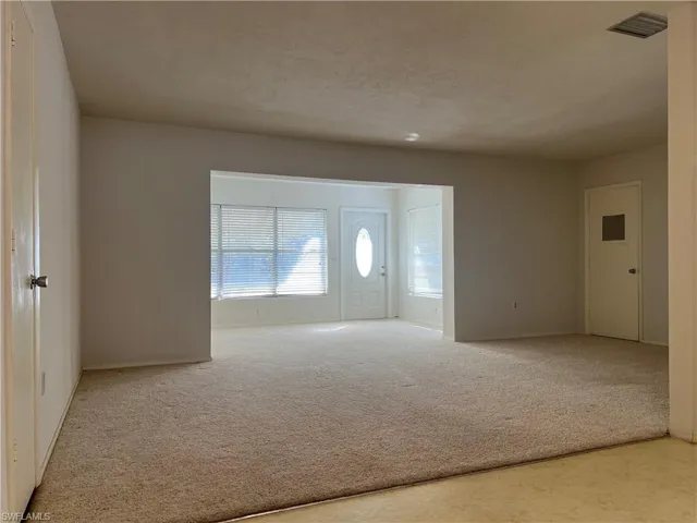 Entrance foyer featuring carpet and a textured ceiling
