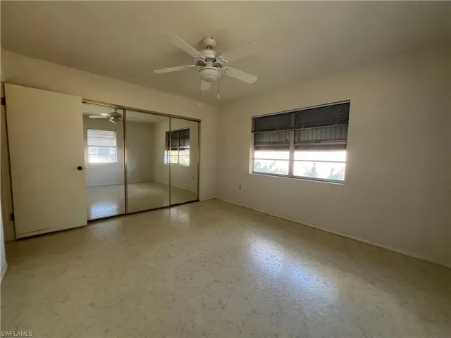 Unfurnished bedroom featuring ceiling fan and a closet