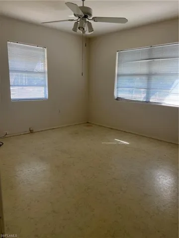 Unfurnished room with plenty of natural light and ceiling fan
