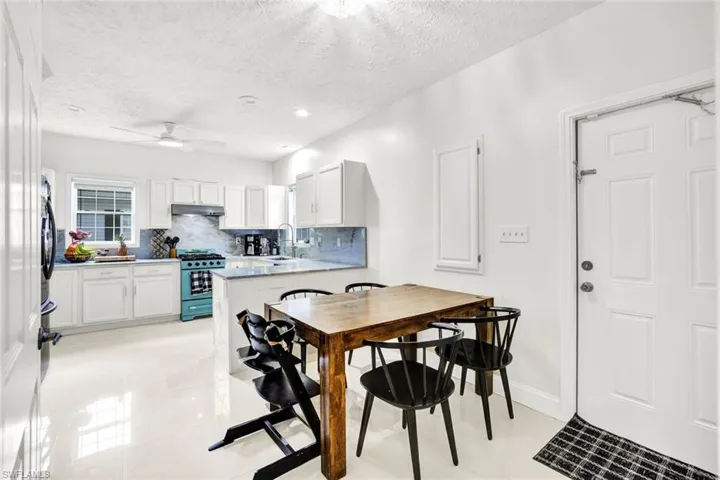 Dining room with a ceiling fan, light tile patterned floors, recessed lighting, and a textured ceiling