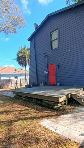View of front of house featuring a balcony and a front yard