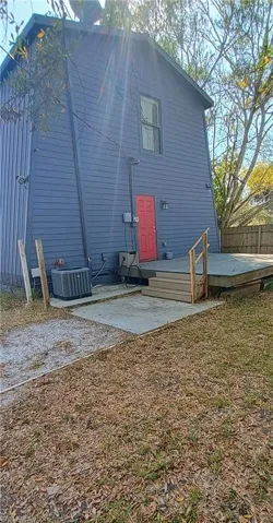 Rear view of property with a deck and a patio