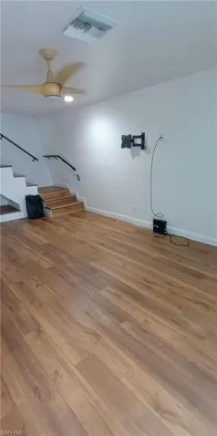 Unfurnished living room with light wood-style floors and ceiling fan