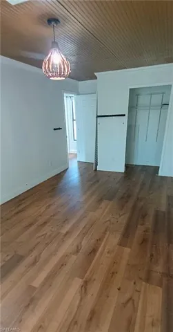 Unfurnished dining area with dark wood finished floors and wooden ceiling