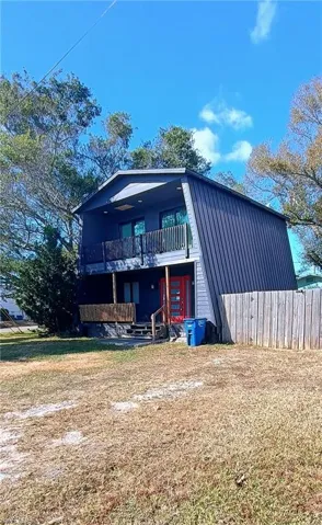 View of front of property with a balcony and a porch