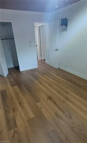 Unfurnished bedroom featuring a closet and wood finished floors