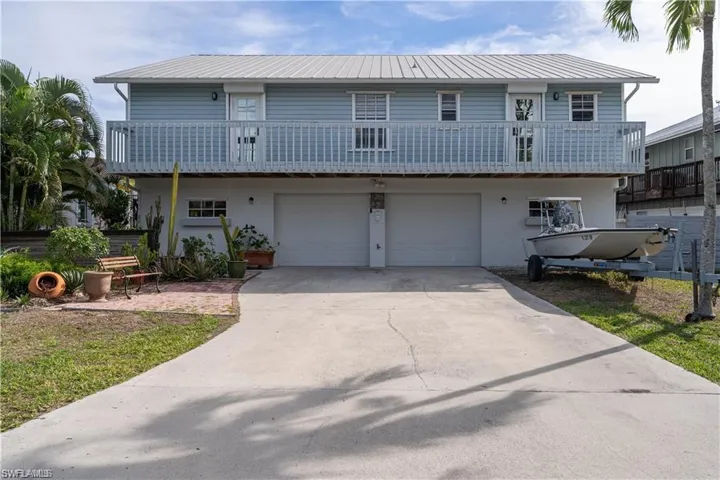 Front facade featuring a garage and a balcony