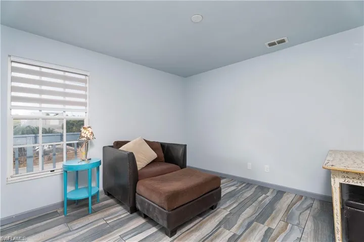 Sitting room with wood-type flooring