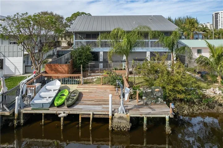 View of dock with a balcony and a water view