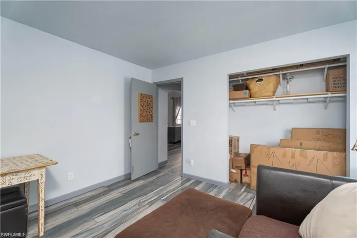 Bedroom with a closet and wood-type flooring