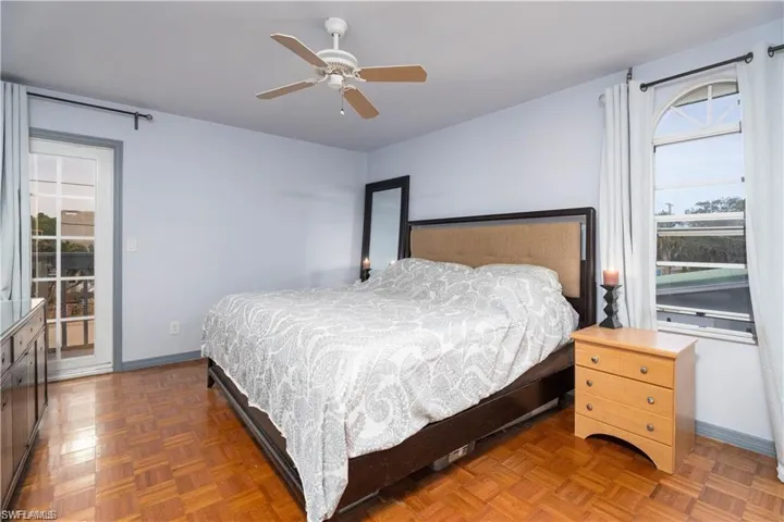 Bedroom with parquet floors and ceiling fan