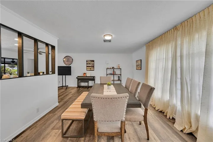 Dining area with a textured ceiling and wood finished floors
