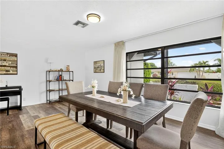 Dining space with dark wood-style flooring