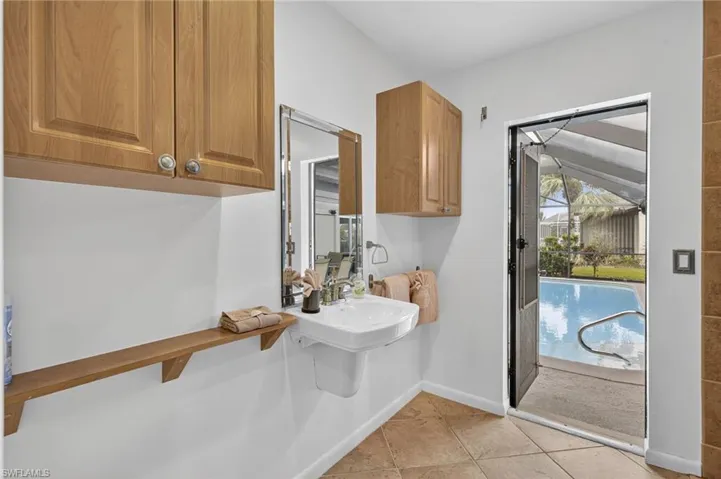 Half bathroom featuring baseboards and light tile patterned flooring