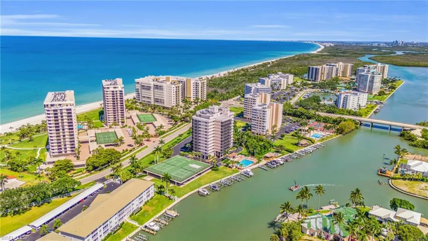 Birds eye view of property with a water view