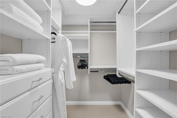 Spacious closet with light tile flooring