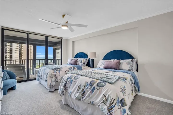 Bedroom with crown molding, access to outside, a wall of windows, ceiling fan, and light colored carpet