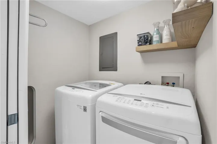 Clothes washing area featuring hookup for a washing machine and washing machine and clothes dryer