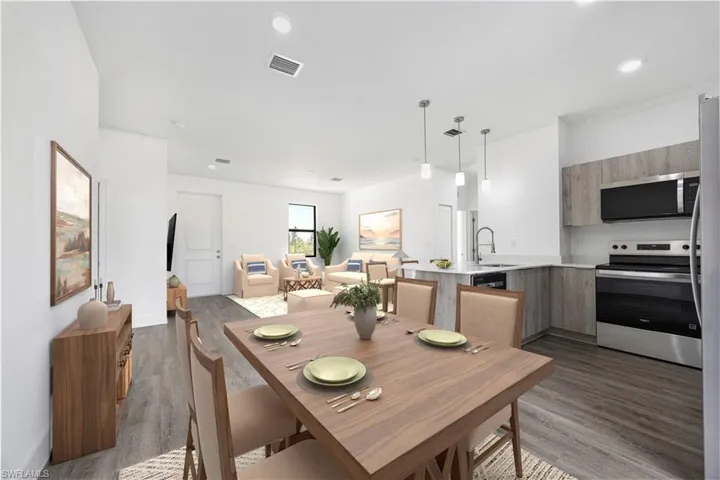 *Virtually Staged*Dining space with dark wood-type flooring and recessed lighting
