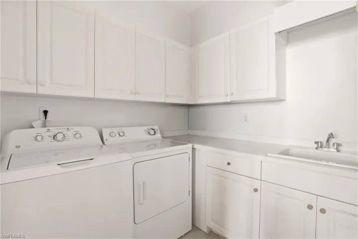 Laundry room with cabinet space and washing machine and dryer