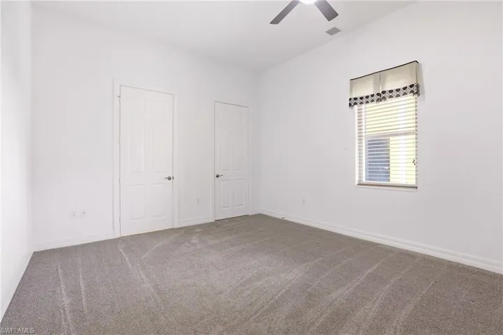 Unfurnished bedroom featuring carpet floors and ceiling fan