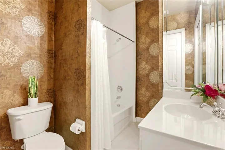 Bathroom featuring vanity and shower / bath combo with shower curtain