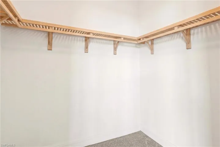 Walk in closet featuring carpet flooring
