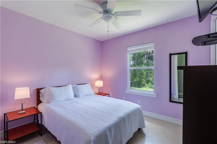 Bedroom featuring a ceiling fan and baseboards
