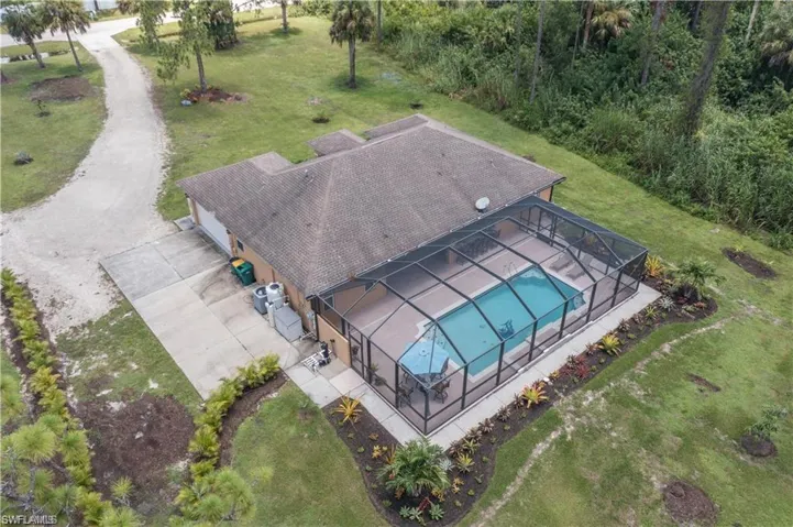 Aerial view of property and surrounding area with a pool area