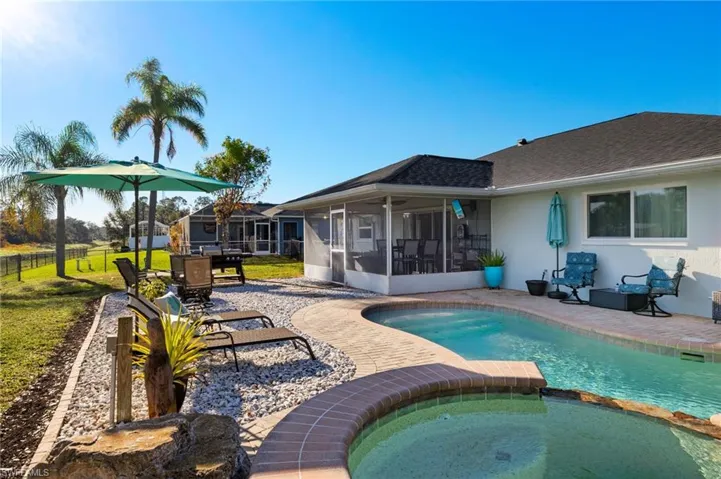 View of swimming pool with a patio area, an in ground hot tub, a sunroom, and ceiling fan