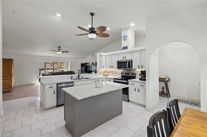 Kitchen featuring white cabinetry, stainless steel appliances, sink, and kitchen peninsula