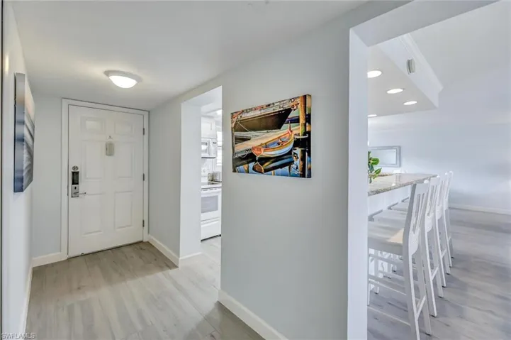 Foyer with baseboards and light wood finished floors