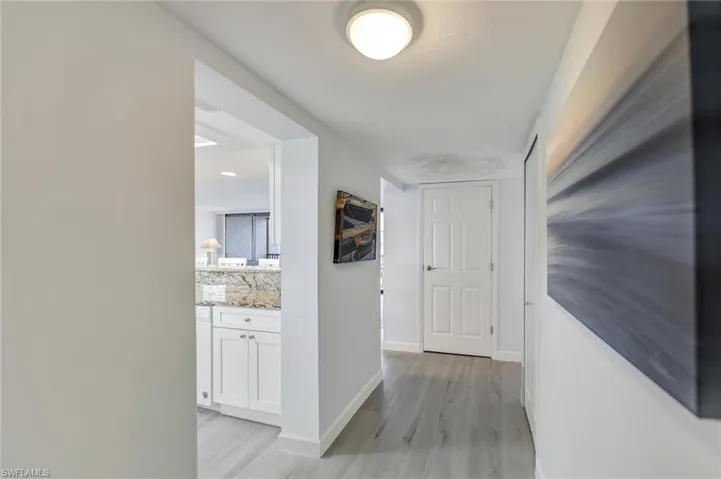 Hallway featuring baseboards and light wood-style flooring
