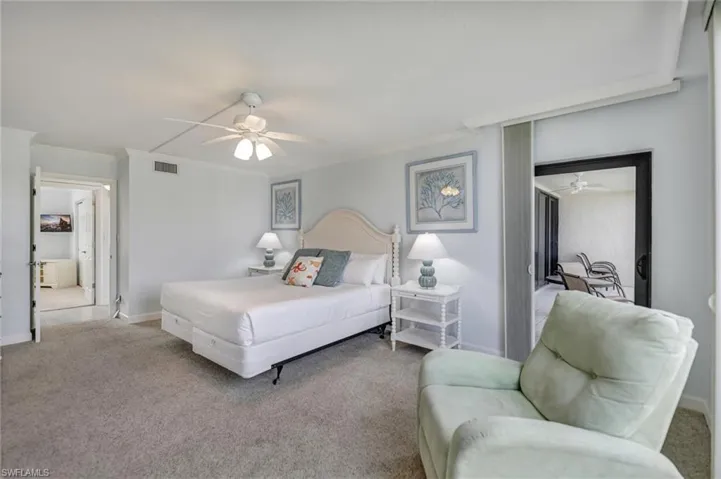 Bedroom with carpet, a ceiling fan, and crown molding