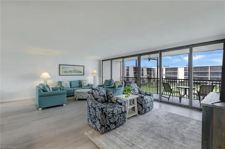 Living area with expansive windows and light wood-style flooring