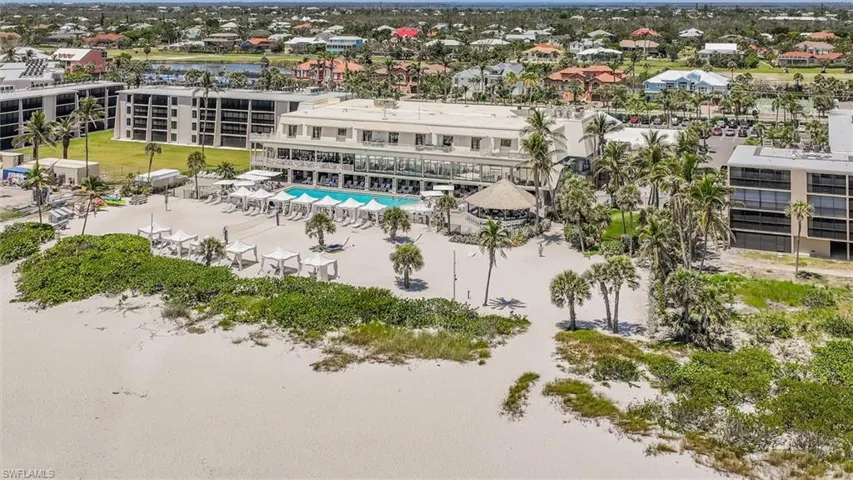 Bird's eye view of a pool area and a nearby body of water