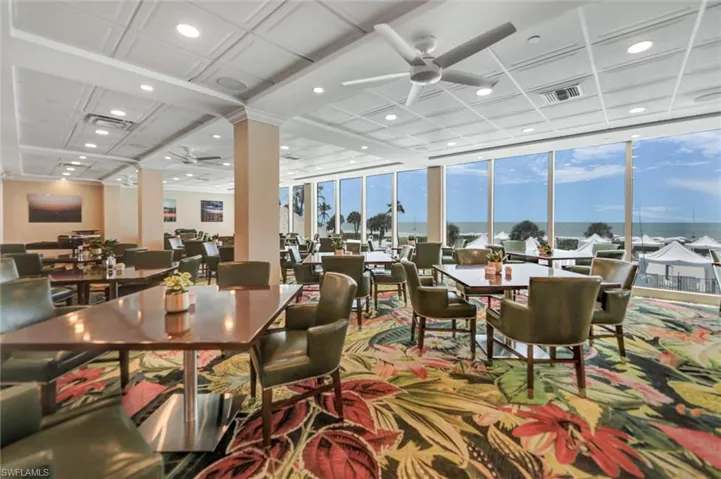 Dining area featuring a ceiling fan, floor to ceiling windows, recessed lighting, a water view, and coffered ceiling